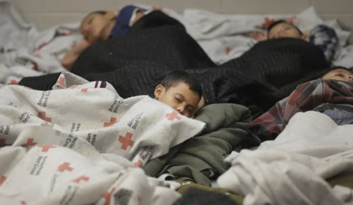 Detainees sleep in a holding cell at a U.S. Customs facility in Brownsville, Texas. Photo via Getty Images