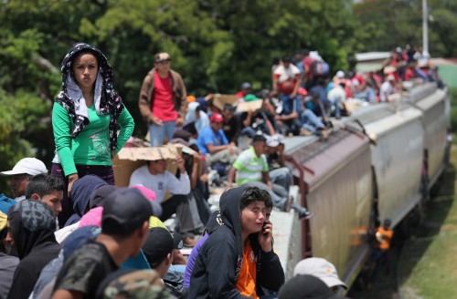 JUCHITAN, MEXICO - AUGUST 06:  Central American immigrants ride north on top of a freight train on August 6, 2013 near Juchitan, Mexico. Thousands of Central American migrants ride the trains, known as 'la bestia', or the beast, during their long and perilous journey through Mexico to reach the U.S. border. Some of the immigrants are robbed and assaulted by gangs who control the train tops, while others fall asleep and tumble down, losing limbs or perishing under the wheels of the trains. Only a fraction of the immigrants who start the journey in Central America will traverse Mexico completely unscathed - and all this before illegally entering the United States and facing the considerable U.S. border security apparatus designed to track, detain and deport them.  (Photo by John Moore/Getty Images)