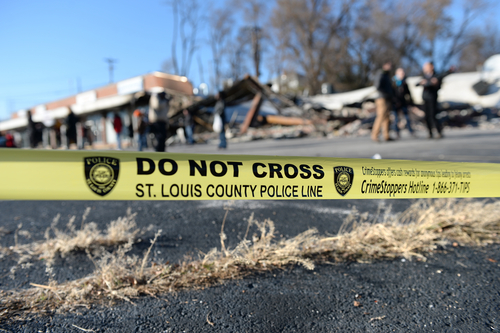 Police tape in front of smoldering remains of Prime Beauty Supply in Ferguson in the aftermath of riots. Photo taken on 11/25/14 by R. Gino Santa Maria / Shutterstock.com.
